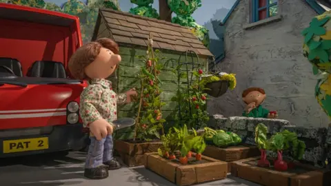 Jonathan Garvey Sara and Julian Clifton outside Postman Pat's cottage