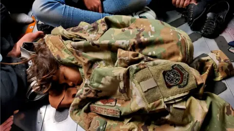 Reuters Afghan child in sleeps on the cargo floor of a US Air Force C-17 Globemaster III