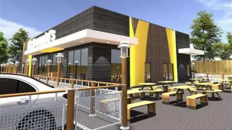 A computer generated image of what the new drive-thru McDonald's on the A2 in Kent could look like - exterior with benches around the building