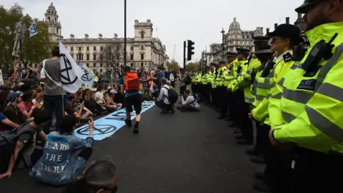 PA Police watch Extinction Rebellion protesters at their final destination of Parliament Square