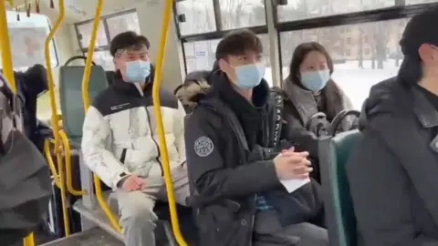 Reuters Foreign students wait in bus to be evacuated from Sumy