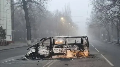 Reuters A vehicle that was burned during the protests in Almaty on 6 January