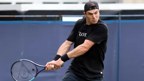 Jack Draper hits a backhand in a practice session at Eastbourne