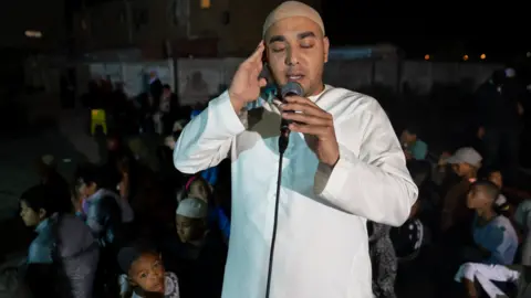 BBC/Shiraaz Mohamed A man calling Muslims to prayer in Manenberg, Cape Town - South Africa