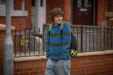 Channel 4 A young man in a blue and green striped jumper
