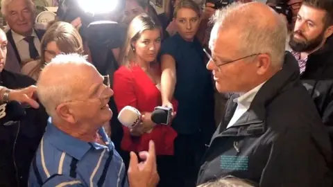 Older man confronts Australian Prime Minster Scott Morrison