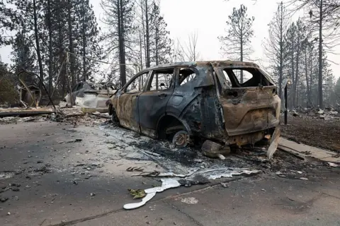 Getty Images A car burned down to its core by a wildfire near Spokane, Washington