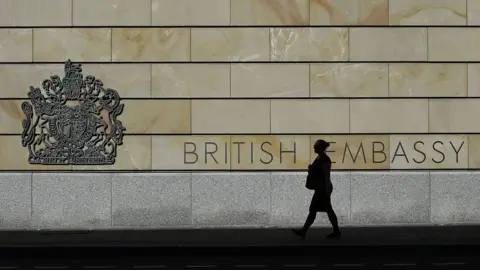 Getty Images A woman walks past the UK embassy in Berlin