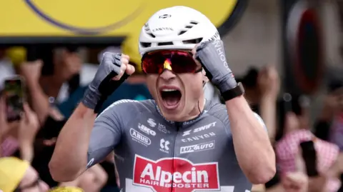 Jasper Philipsen celebrates winning stage one of the 2025 Tour de France