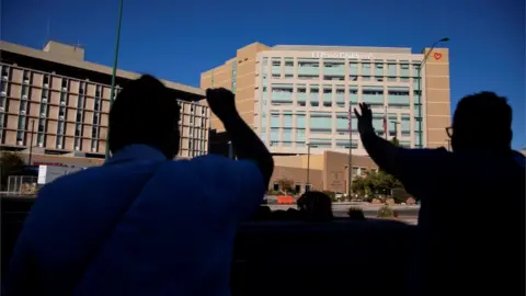 Reuters People praying outside El Paso hospital