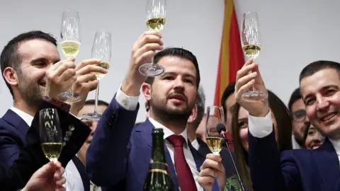 Reuters Jakov Milatovic and party mates with champagne