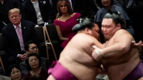 AFP Donald Trump and First Lady Melania Trump watch a sumo battle. 26 May 2019