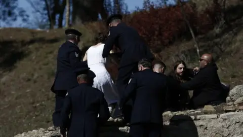 EPA Policemen detain Tibetan activists holding a Tibetan flag after they invaded the Olympic flame lighting ceremony