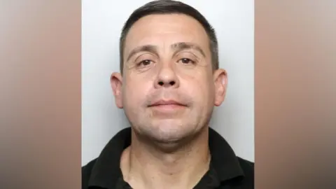 A mugshot of Sale who has brown hair and brown eyes.