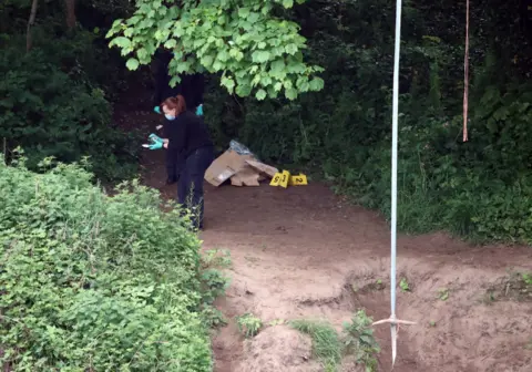 NORTH NEWS AND PICTURES Forensics crews near a swing on Sunday morning