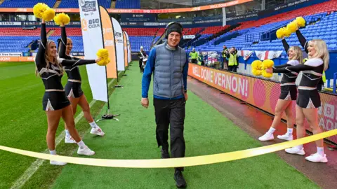 Vernon Kay crosses the finish line