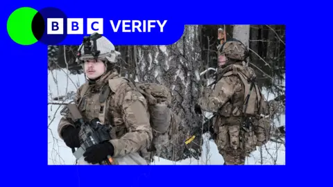 EPA-EFE/REX/Shutterstock UK troops on Nato cold weather exercises in Estonia. Two soldiers can be seen in the snow, wearing camouflage gear and helmets and holding rifles. The BBC Verify logo is overlaid on top. 