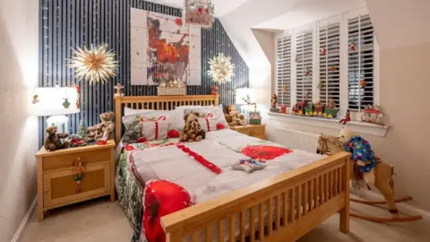 Kirsty Anderson Bedroom decorated with teddy bears, a rocking horse and other festive Christmas decorations. 