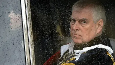 Former prince Andrew looking out of the car window (file picture)
