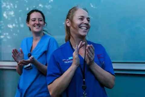 Vickie Flores / EPA-EFE Staff from the Royal London Hospital take part during the Clap for our Carers