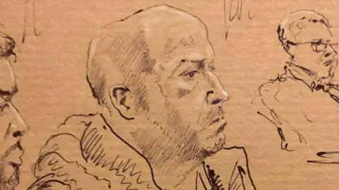 Mike O'Donnell Court Artist A brown paper court sketching of Riad Bouchaker. He looks side on, to the right of the page. It appears he has short shaven hair on the back and side of his head and bald on top. A man with short hair and glasses is to his left. 