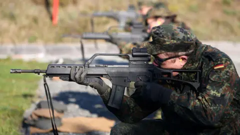 Getty Images German volunteer trains with a rifle, October 2024