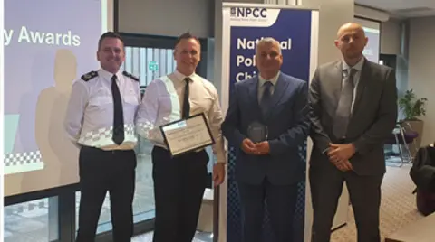 Warwickshire Police A composite image showing a group of four men receiving the certificate.