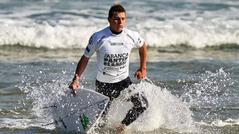 Arran Strong competing at a surfing event in Spain in 2020