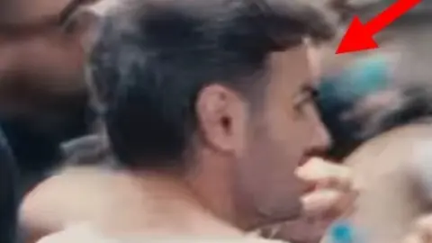 Avon and Somerset Police A man with black hair looking sideways and his back to the camera