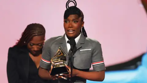 Getty Images Doechii holds her Grammy award