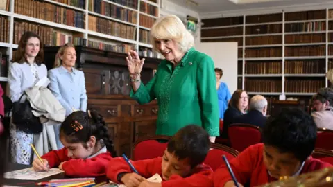 PA Media Queen Camilla with local school children during a visit to Robinson Library, Armagh, Co Armagh,