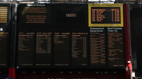 EPA/Shutterstock An arrivals and departures board shows delays and cancelations at Lime Street railway station in Liverpool