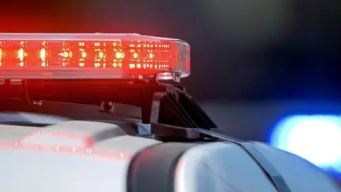 A stock image showing police car lights in red.