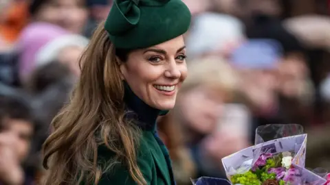 The Royal Family A picture of a smiling Kate at Sandringham over Christmas