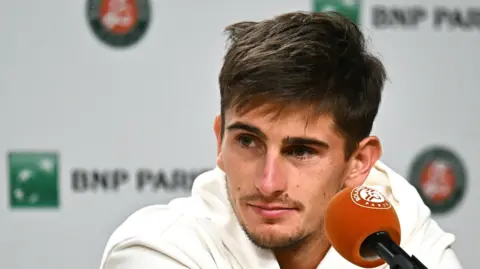 Matteo Arnaldi looks rueful