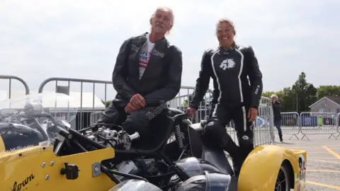Alan and Leila leaning on their sidecar racer. 