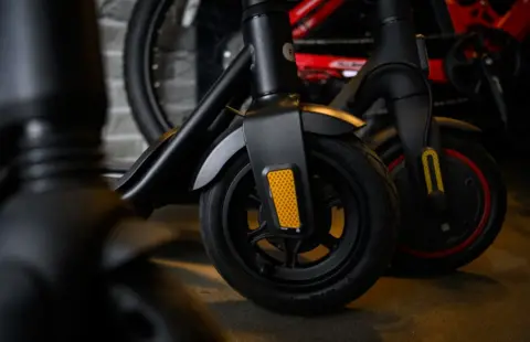A close up image of the wheels of e-scooters.