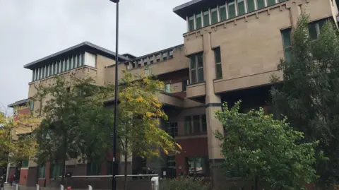 Exterior of Sheffield Crown Court, with trees in the foreground.