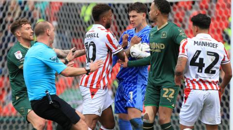 Players from Stoke City and Plymouth Argyle clash