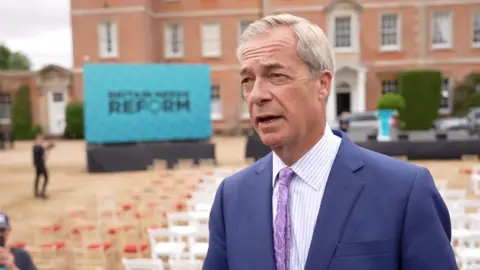 Nigel Farage wearing a purple tie and blue suit jacket.
