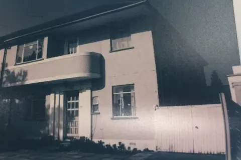 WENDY LEWIS Front of Wendy's house with parents' house to the right.