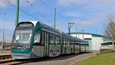 NET Nottingham tram setting out from its depot on a sunny day