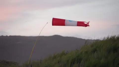 Oxfordshire County Council A meteorology wind bag in a field, swaying in the wind.