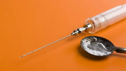 Alamy Needle and heroin on spoon