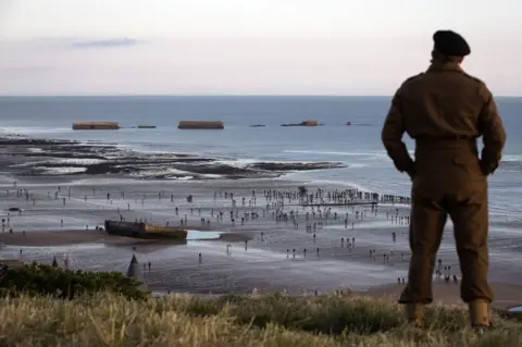 Getty Images People dressed as soldiers on a beach