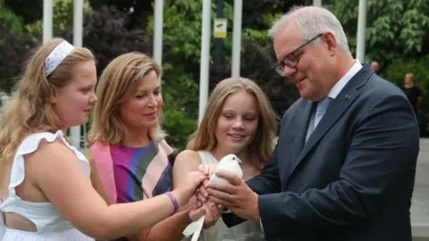 SCOTT MORRISON/INSTAGRAM Scott Morrison and his wife and two daughters hold a bird
