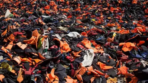 Getty Images Thousands of discarded life vests in the hills above Mithymna, Greece, in 2016