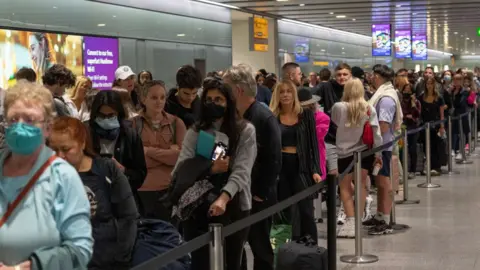 Getty Images Queues for security at Heathrow Airport in June