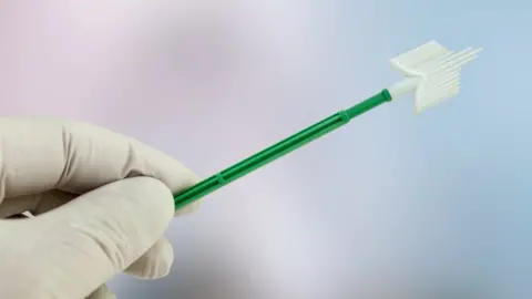 Getty Images A gloved hand holding a gynaecological swab used in a smear test