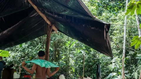 Camilo Mejia A "raspachin" (field hand) takes a break from processing coca leaves in the jungle of Putumayo